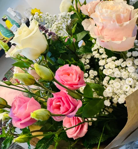 Bouquet of pink and cream roses with gypsophila