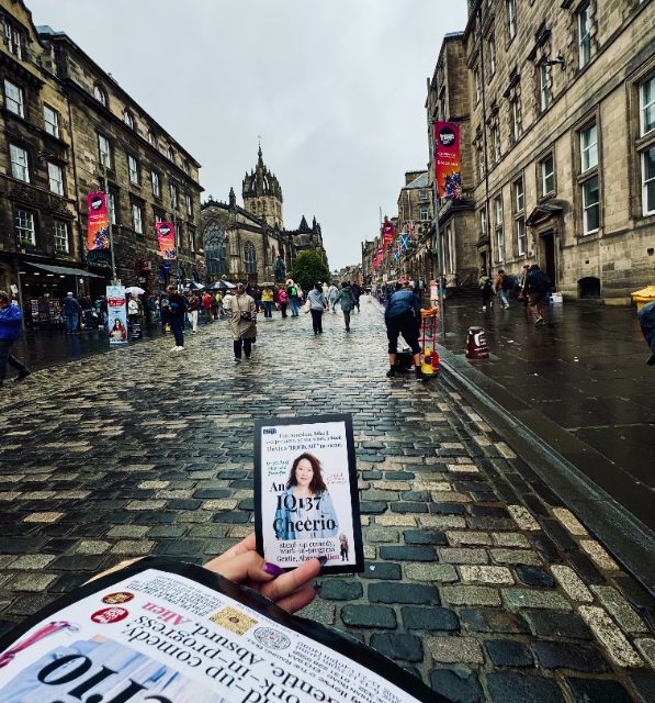 Holding an An IQ137 Cheerio flyer on the rainy cobbles of the Royal Mile